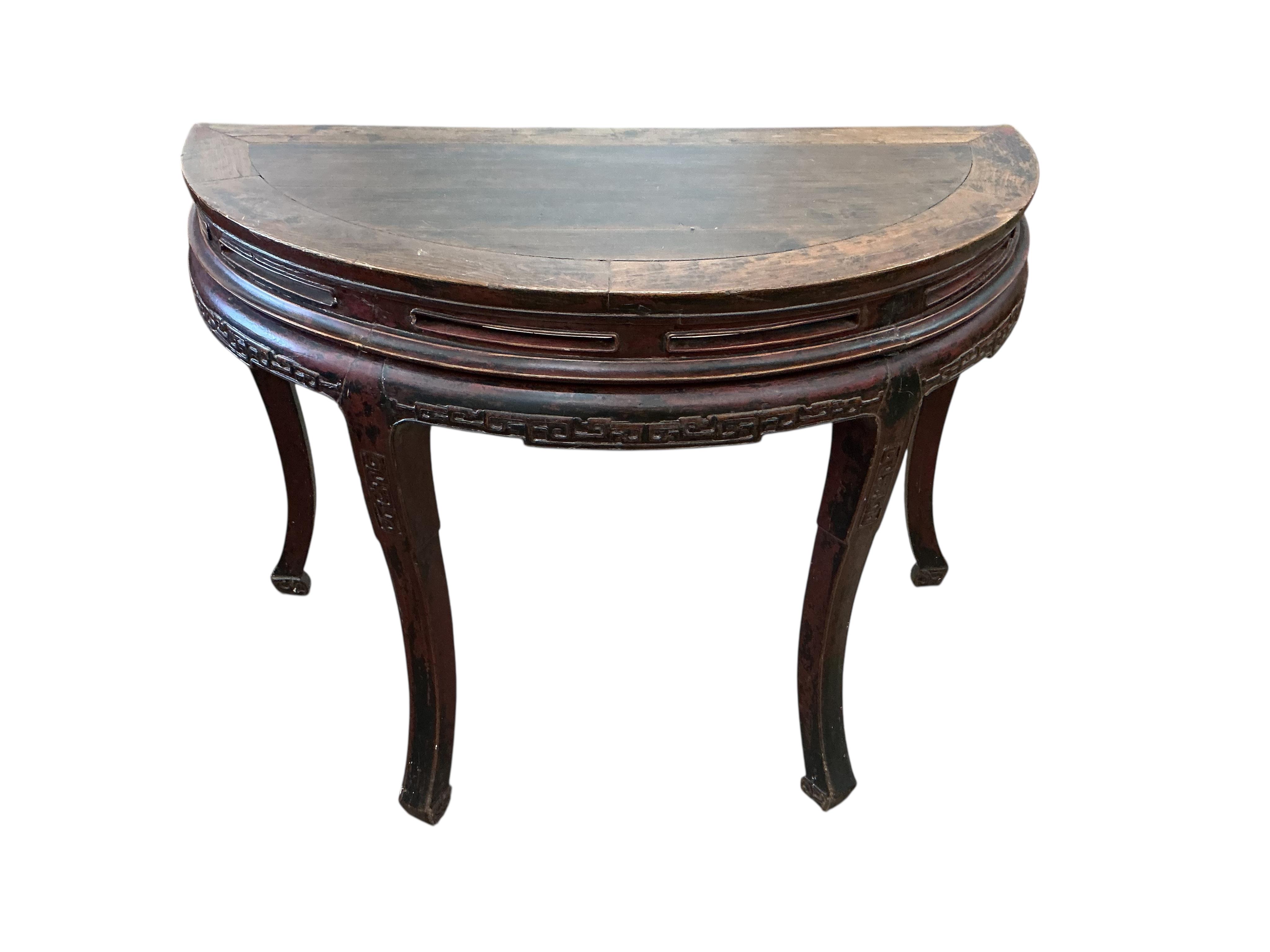 A pair of Chinese part lacquered demi lune console tables, width 124cm, depth 63cm, height 90cm